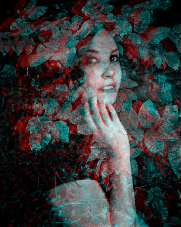 3D image with separate cyan and magenta layers that shows a multiple exposure image of a woman touching one hand lightly to her chin, surrounded by leaves.