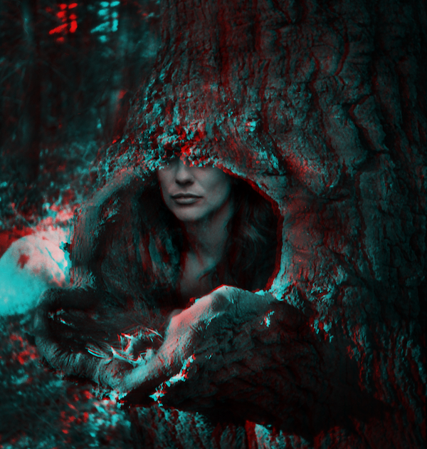 3D image with separate cyan and magenta layers that shows a multiple exposure image of the bottom half of a woman's face inside a hollow tree trunk.